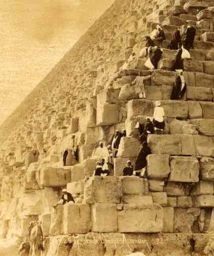 Egyptians stand on the rising courses, each stone half as tall as they are